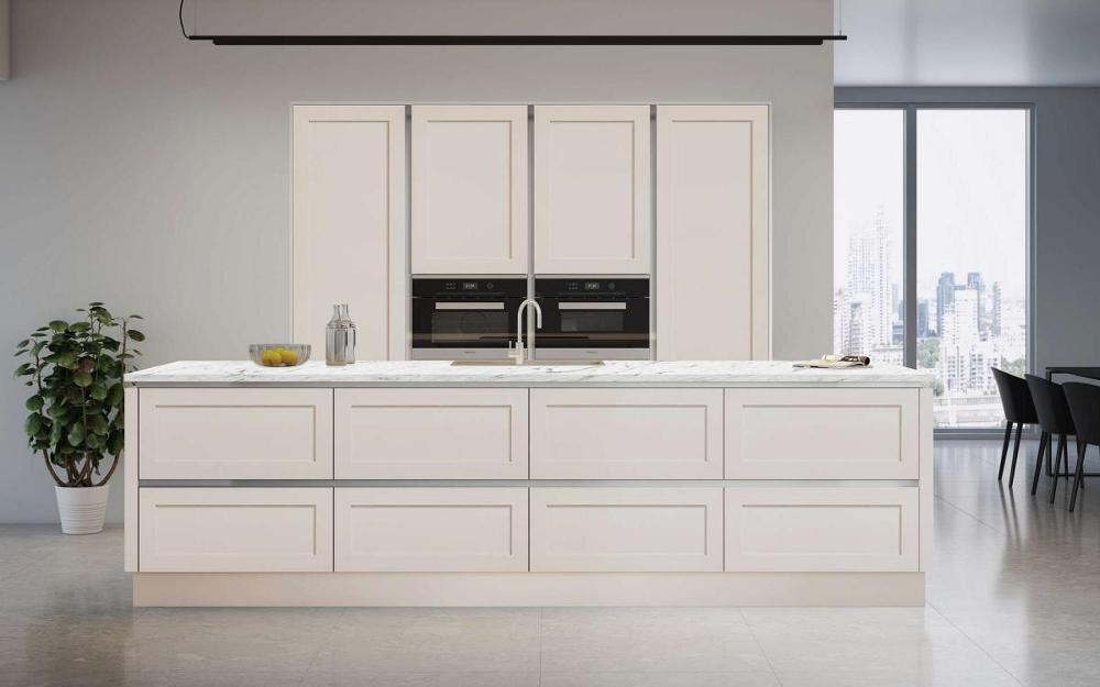Open plan kitchen with island, white grey veined quartz worktops, recessed tall units in True Handleless Shaker Door Details Kashmir style.