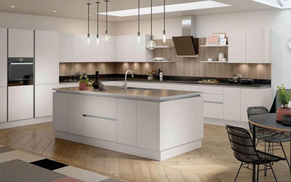 Smooth painted flat slab door kitchen with large central island, black worktops in Cassina Taupe style