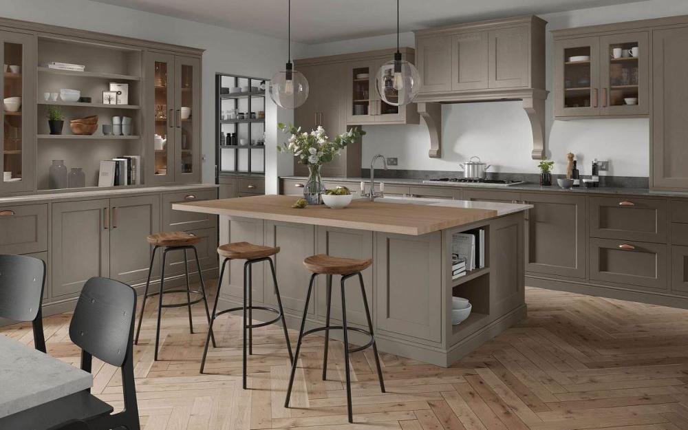 Kitchen with large island, two layered worktop, large glass window, and over hob canopy feature in Portwood Stone Grey style