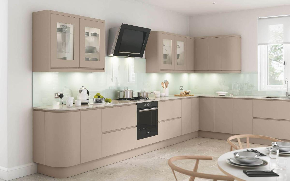 L-shaped kitchen with ivory worktops, built-under oven, and curved end base unit in Moderna Stone style