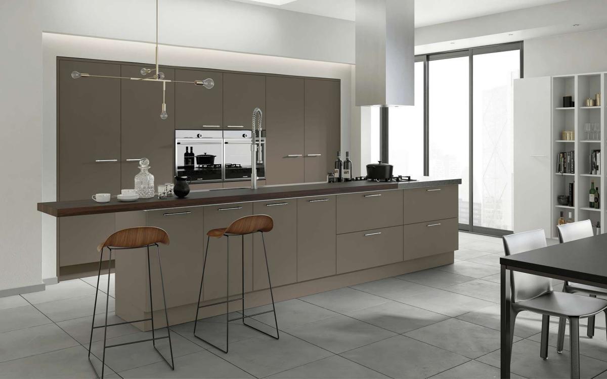 Smooth painted slab door kitchen with long island feature and recessed tall units in Velluto Stone Grey style