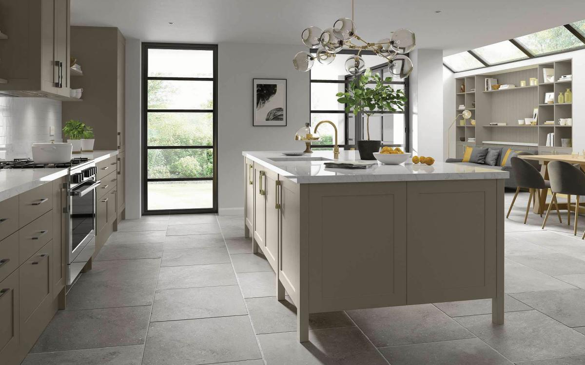 Smooth painted narrow frame shaker door kitchen with large island feature and grey quartz worktops in Millwood Stone Grey style