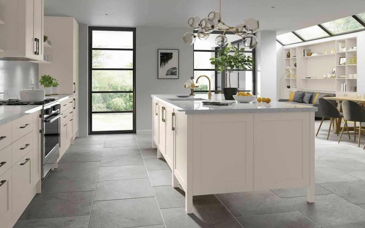 Smooth painted narrow frame shaker door kitchen with large island feature and grey quartz worktops in Millwood Taupe style