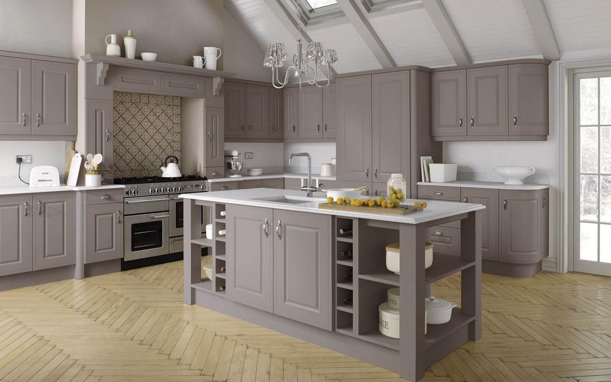 Large country kitchen with vaulted ceiling, chunky posts on island corners, and large overmantle feature in Helmsley Stone Grey style