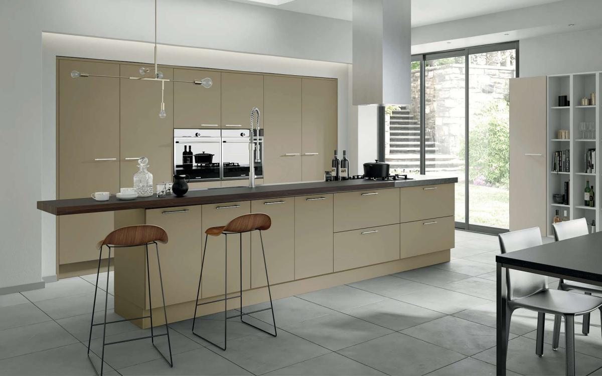 Smooth painted slab door kitchen with long island feature and recessed tall units in Velluto Dakar style