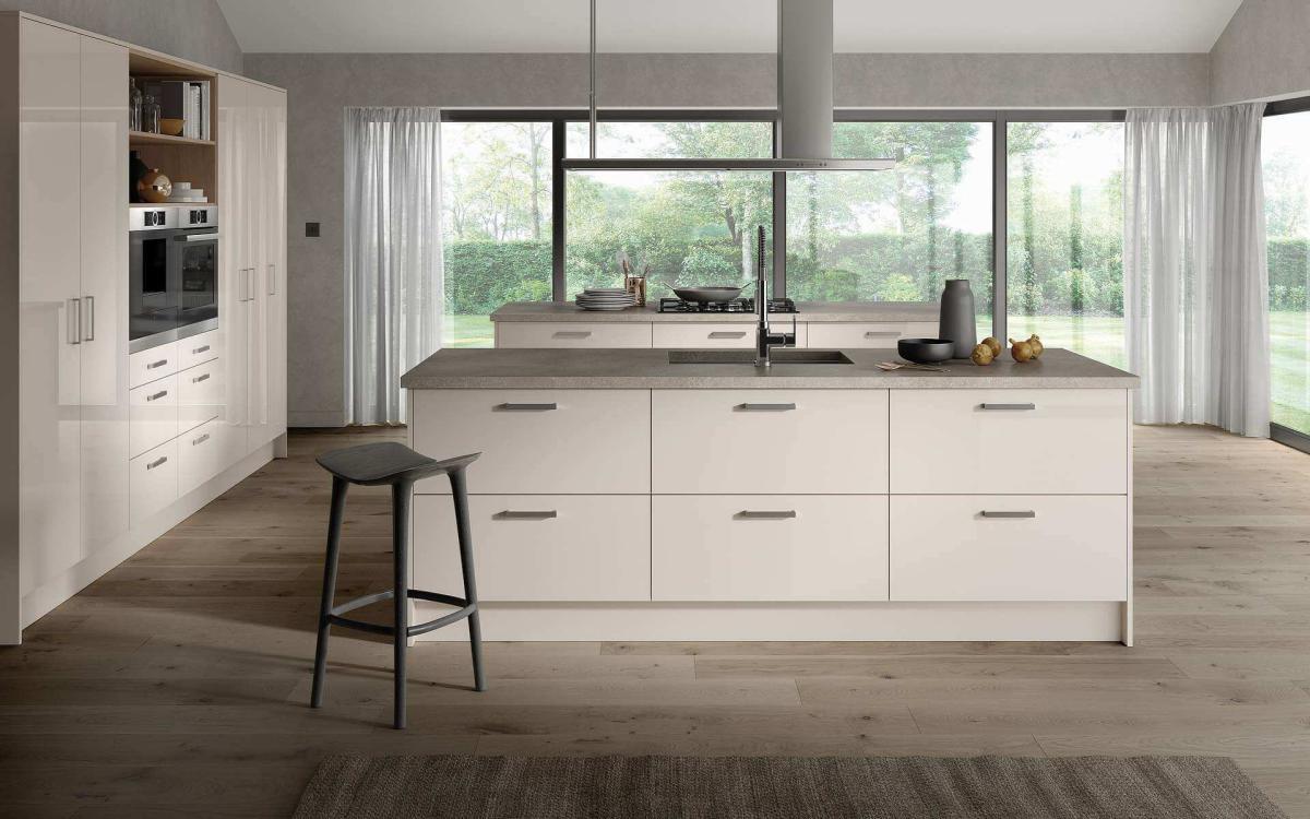 Flat slab kitchen style with two islands, tall bank of units, and large windows in Treviso Cashmere Gloss style