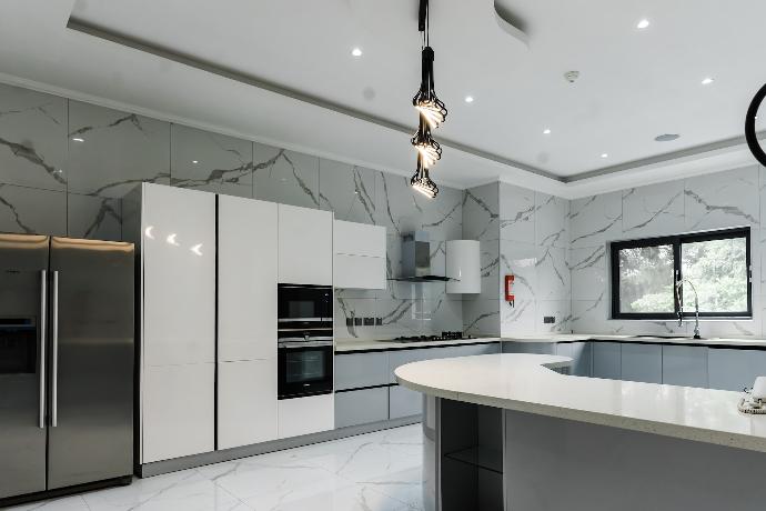 a modern kitchen with marble counter tops and stainless steel appliances