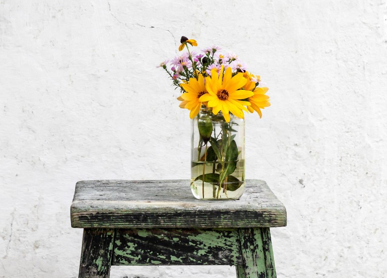 sunflower with clear glass vase on gray table
