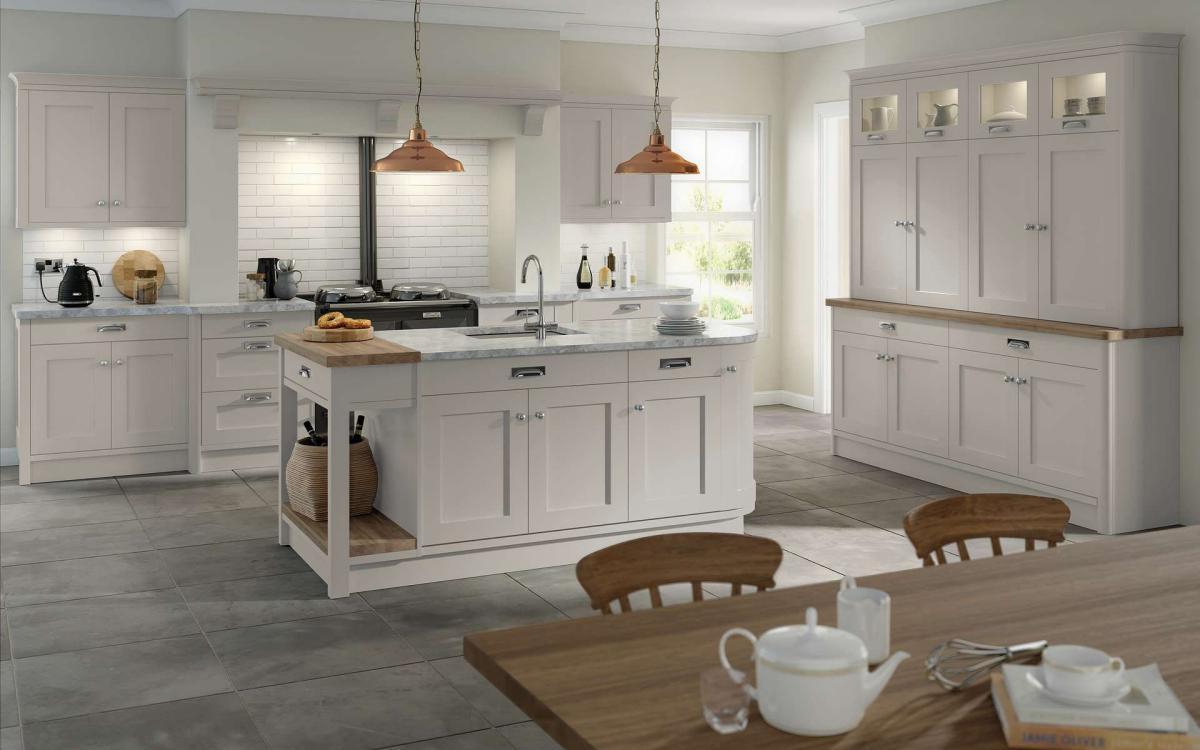 Country style kitchen with island, open fireplace, overmantle shelf, and large dresser in Bewdley Taupe style