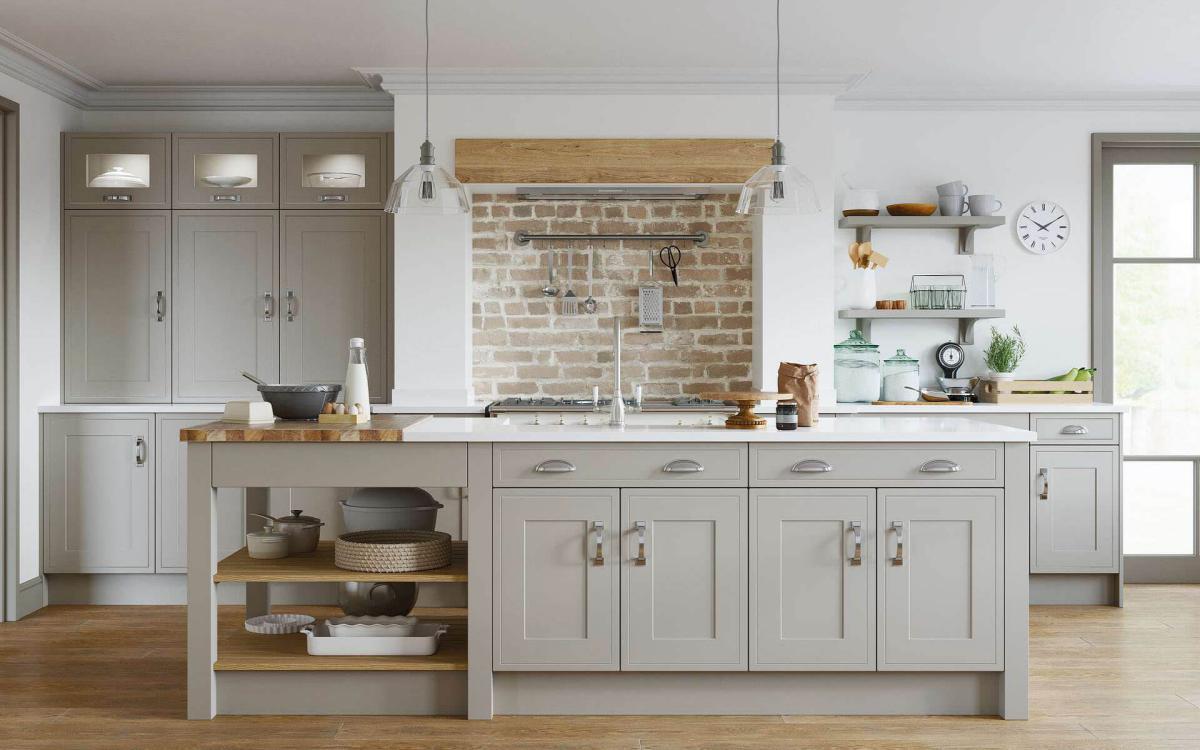 Shaker in-frame effect door style kitchen with island and pastry bench feature in Dewsbury Pebble style