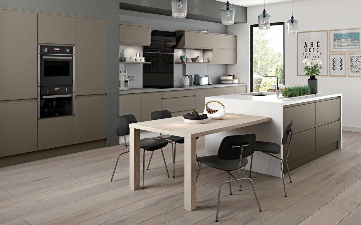 Spacious kitchen with white worktop island, waterfall end features, and recessed bank of tall units in Marino Stone Grey style