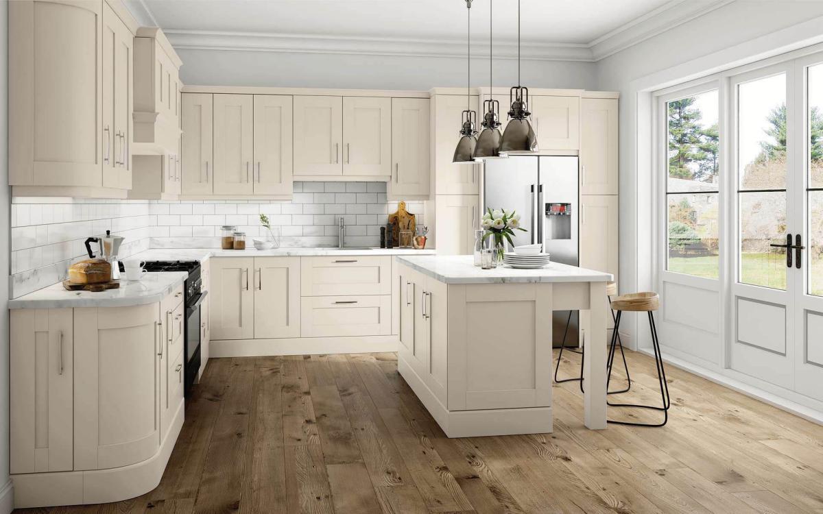 Kitchen with chunky leg posts island, American fridge, and black range oven in Elsworthy Dakar style