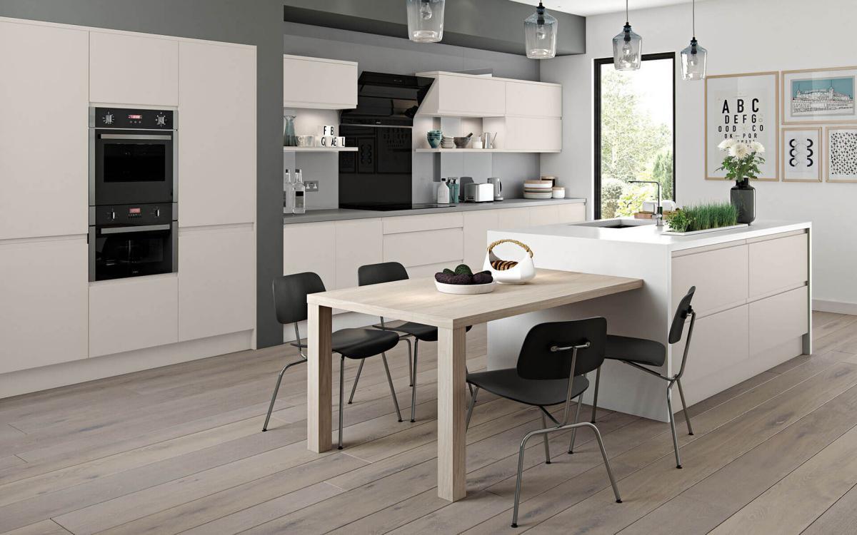 Spacious kitchen with white worktop island, waterfall end features, and recessed bank of tall units in Marino Taupe style