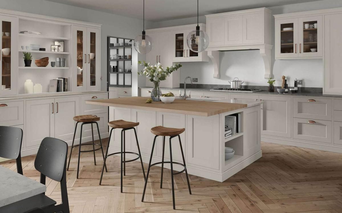 Kitchen with large island, two layered worktop, large glass window, and over hob canopy feature in Portwood Taupe style