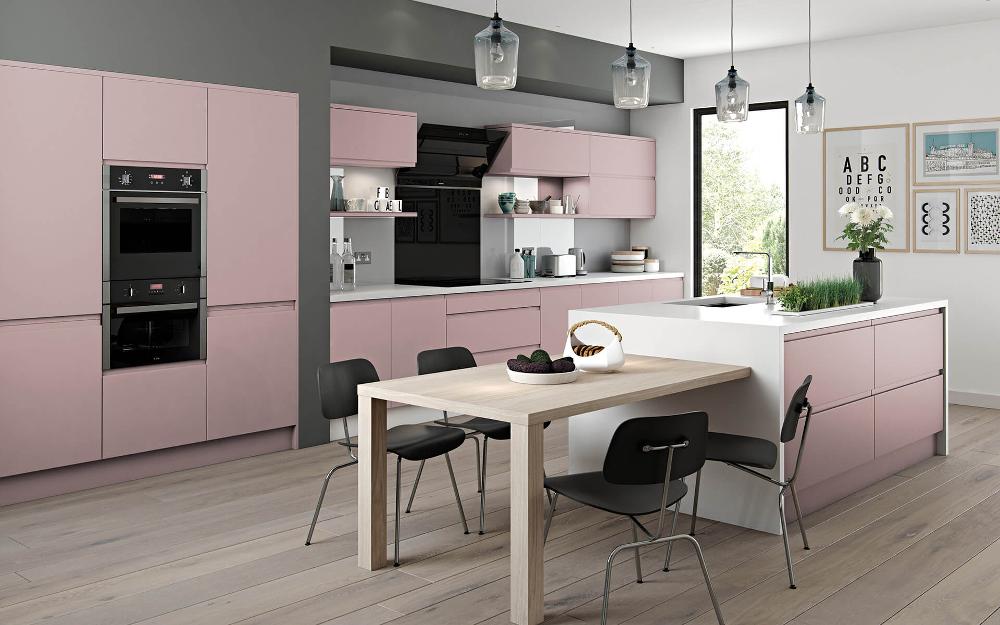 Pink Handleless J Pull Kitchen with white worktop and built in table feature
