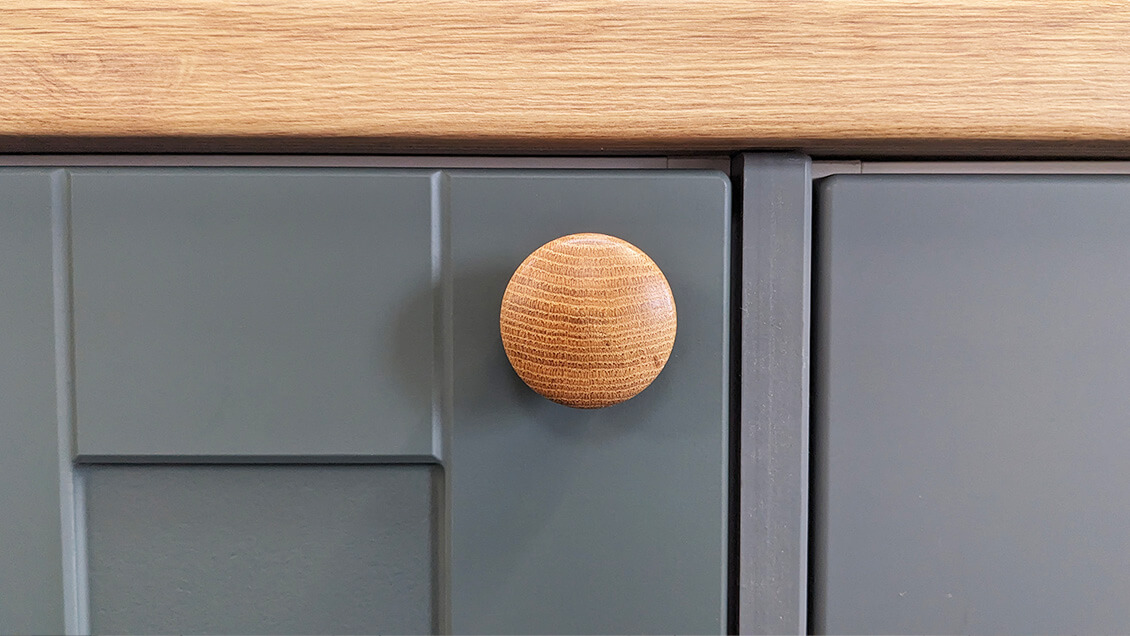 Happy smile on Wooden Oak Knob with upward woodgrain direction Better Kitchens